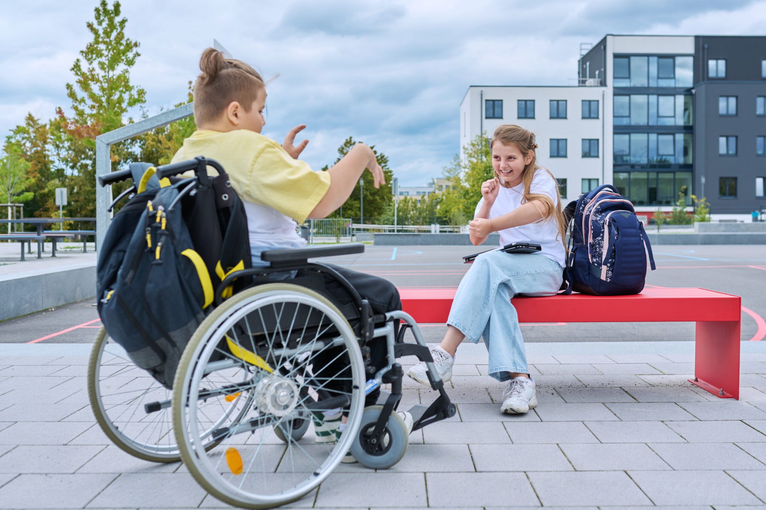 Friendship communication of children of boy in wheelchair and girl